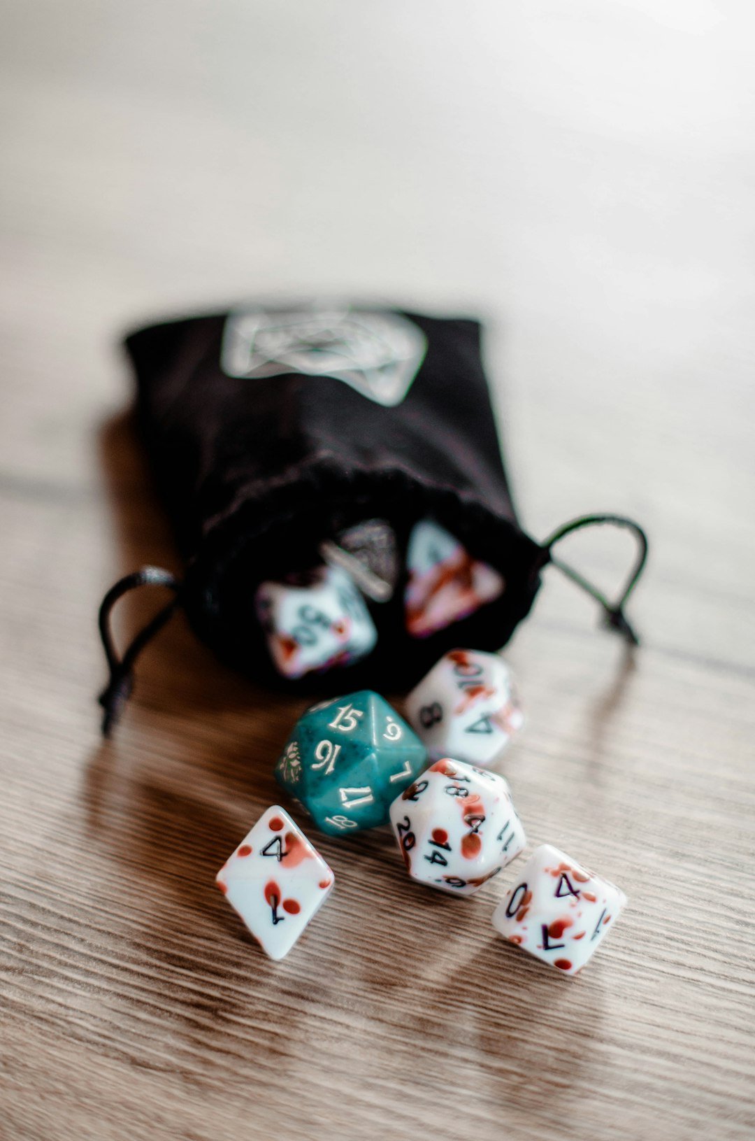 a-bag-filled-with-dice-sitting-on-top-of-a-wooden-table-tmzftjxtorc