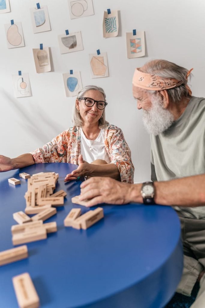 Senior couple engaging in a block game at home, savoring a relaxed moment together.